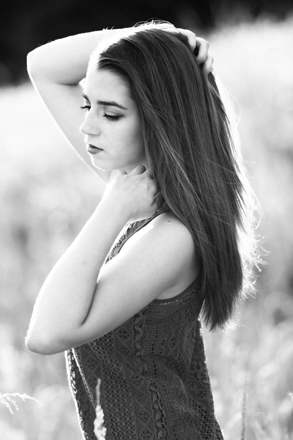Leah strikes a poses in a field of tall grass as the sun sets behind her. A huge part of my business is senior portraits, capturing high schoolers before they head off to college.